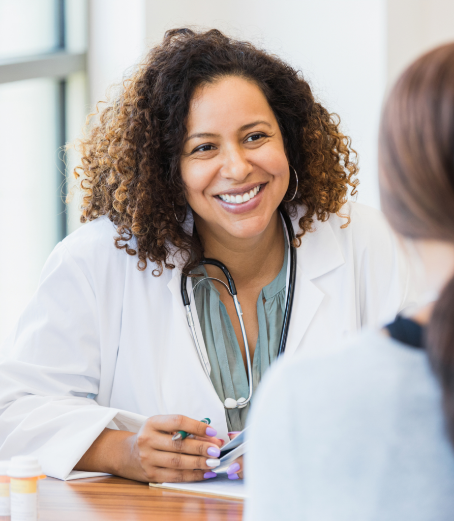 A Doctor in White Coat speaks with her patient